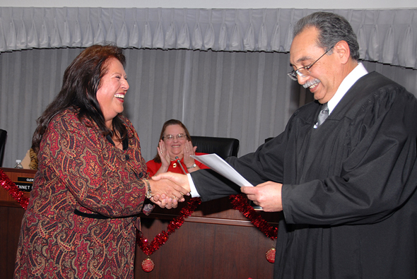 Janet Rivera shakes hands with Judge Jose Alva.