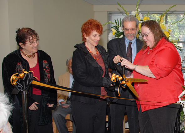 Members of the Goleman family prepare to cut the ceremonial ribbon.