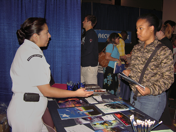 Job Fair attendee speaks with a potential employer.