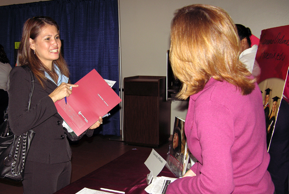 Job Fair attendee speaks with a prospective employer.