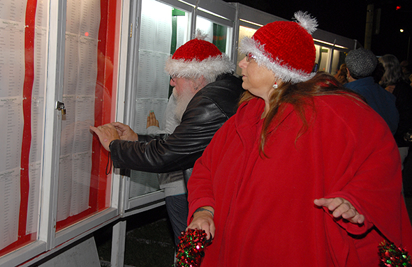 Hospice donors find a loved one's name on the marquee under the Hospice Tree of Lights.