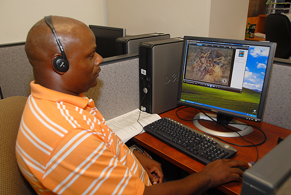 Veteran works at a Computer in Delta's Veteran Resource Center