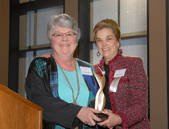 Phyllis Grupe presents kathy hart with the 2013 Athena Award