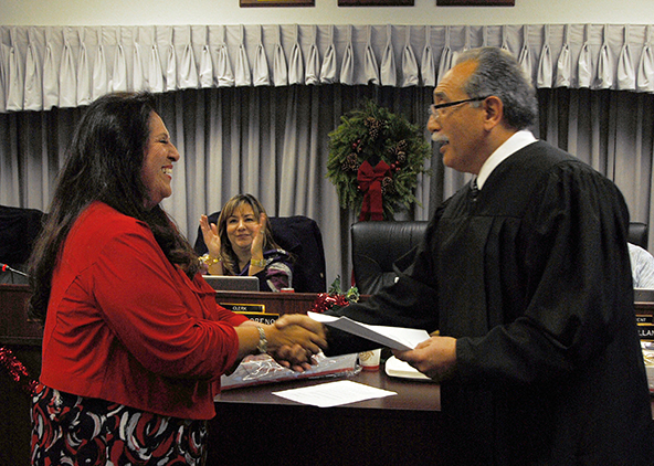 Janet Rivera receives congratulations from Judge Jose Alva.