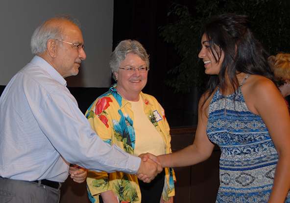 Former Trustee Taj Khan and Superintendent Kathy Hart congratulate a scholarship recipient at the 2014 ceremony.