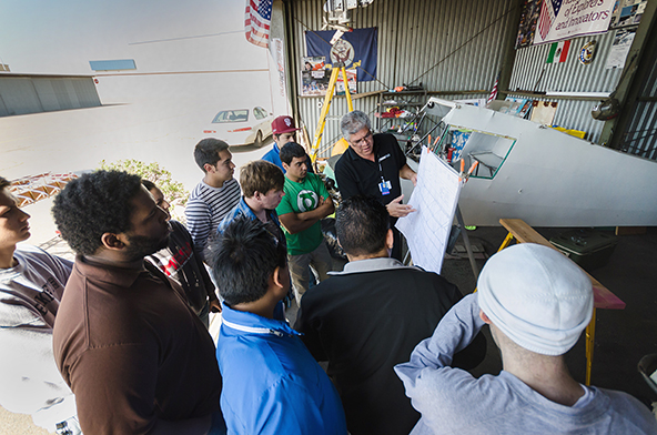 Delta engineering students work on the Taylor Craft Airplane at the Stockton Airport.