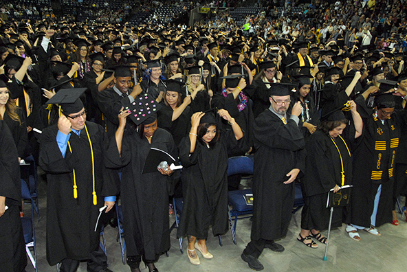 The Class of 2015 moves the tassels from right to left on graduation, as is traditional.