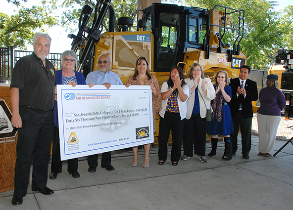 Paul Jacobs of CARB presents a check for $46,942 to Dr. Kathy Hart and Delta College trustees.