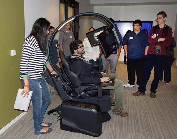 Student Juan Medina sits in the Microsoft Multi-Screen, Multi-Sensory System