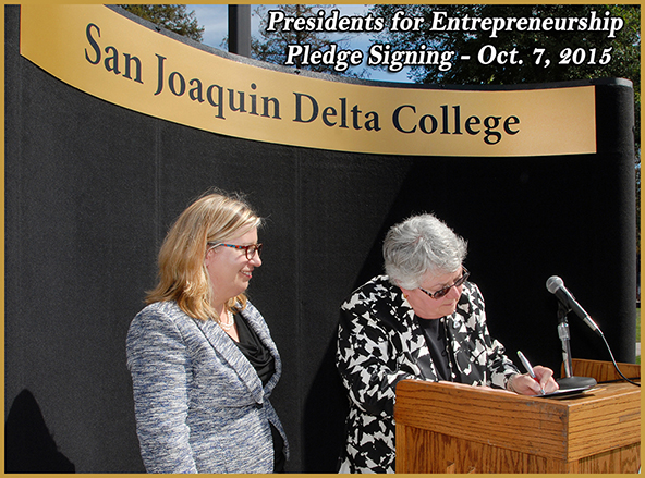 Amy Schultz, representing NACCE, watches as Dr. Kathy Hart 