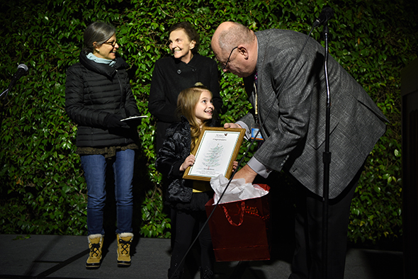 Tree of Lights Program Cover Contest winner Neve Giannini recieves the award from Lou Meyer, President, Hospice of San Joaquin Board of Directors