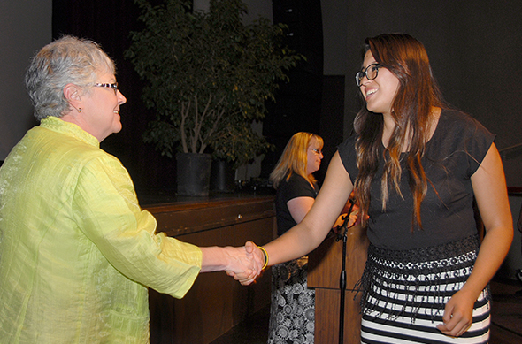 Superintendent/President Kathy Hart greets a scholarship award winner.