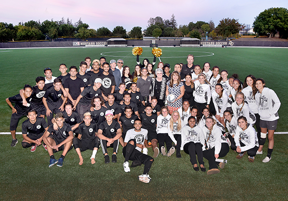 Both Mustangs Soccer teams, staff and management got together for a group photo after the ribbon-cutting.