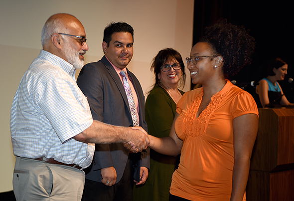 Trustees Steve Castellanos, Richard Vasquez and Board President Janet Rivera greet recipients.