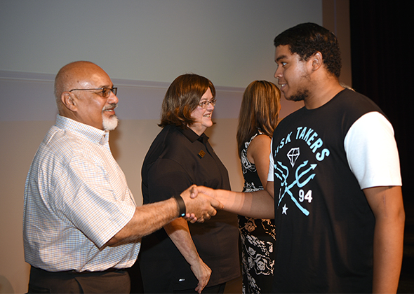 Delta Trustee Steve Castellanos greets a scholarship recipient.