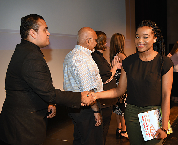 Former Delta College Student Trustee Rafael Medina greets a scholarship recipient.